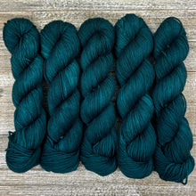 Load image into Gallery viewer, Five skeins of dark teal yarn on a wooden surface
