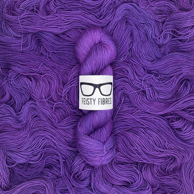Purple yarn skein with a 'Feisty Fibres' label on a purple background