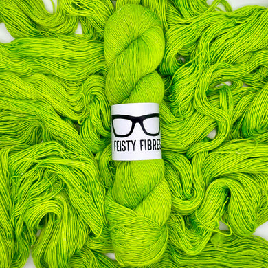 Bright green yarn with a 'Feisty Fibres' label on a white background